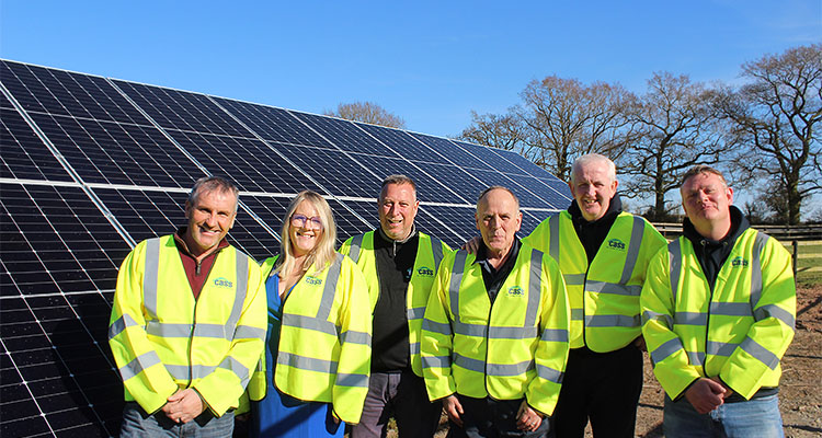 CASS workers in front of a Solar Panel in a field
