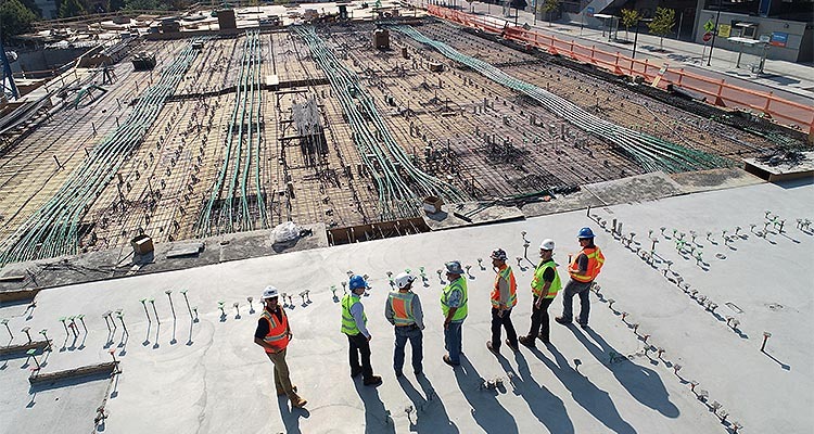 Construction workers looking over the foundations of abuilding