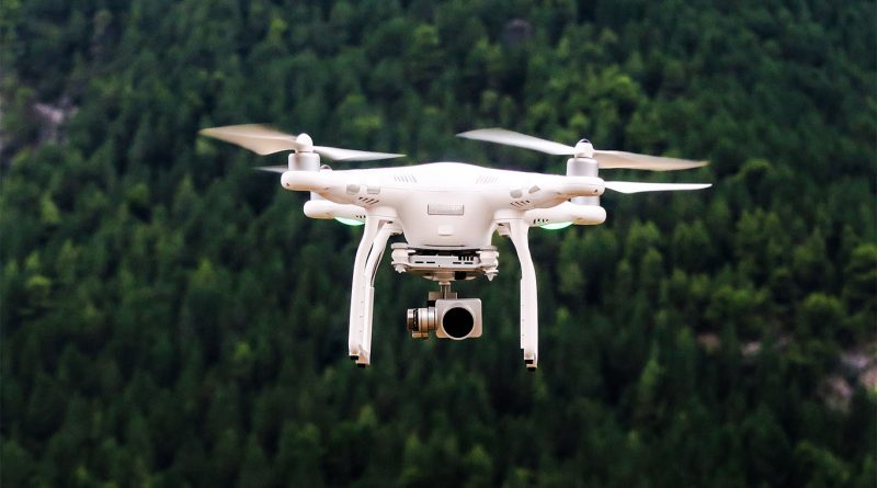 Image of a white drone flying in the sky to support drone delivery image