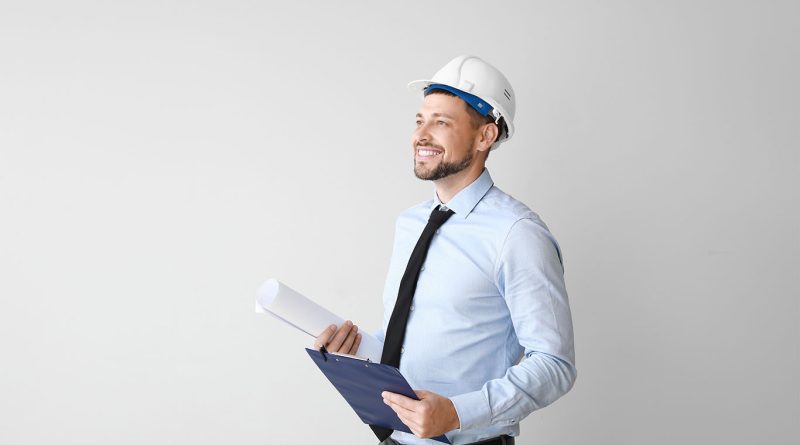 Image of a male engineer stood smiling with a hard hat on to support Mott McacDonalds Engineer Returnes Program article