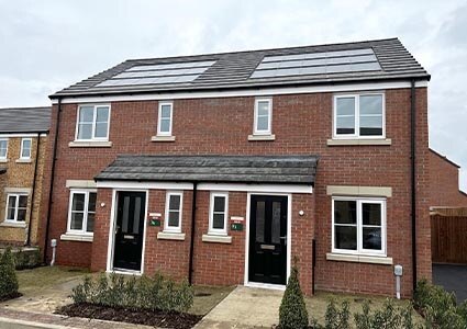 Two semi-detached houses with solar panels on the roof