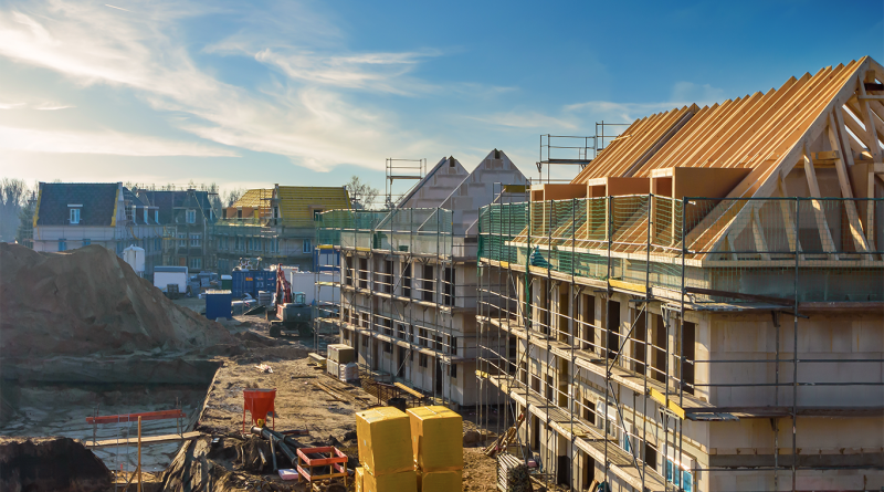 Image of a row of houses being built with scaffolding all around them to support Blackstone construction article