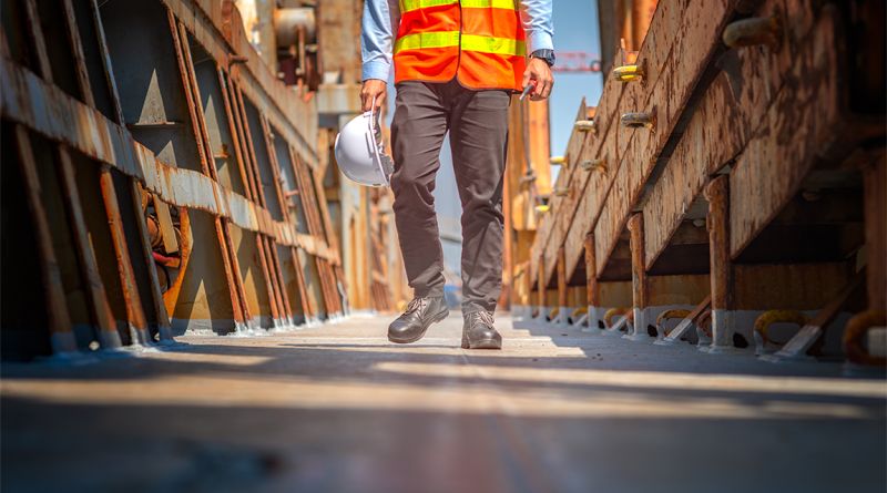 Man walking through a construction site holding hard hat to support Blenheim House Construction article