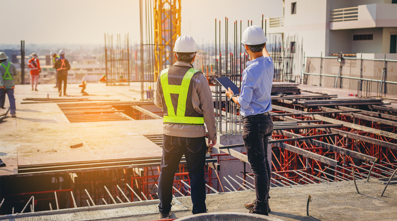 construction worker and inspector stood talking on scaffolding to support construction safety article