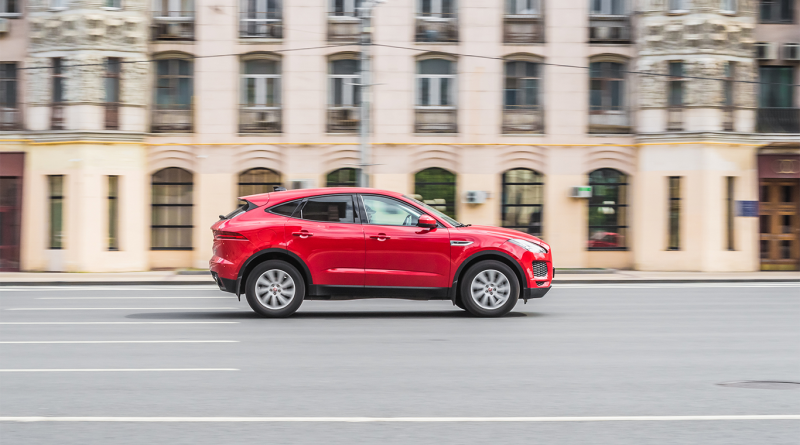 Red JLR cover driving through streets to support Industry 4.0 article
