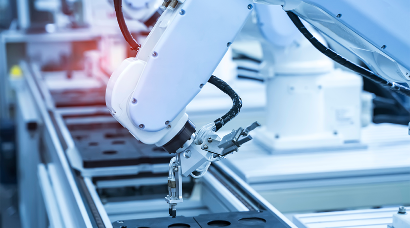 Image of robotic arms working on some machinery and products in a warehouse to support Robotic Micro-Factories article